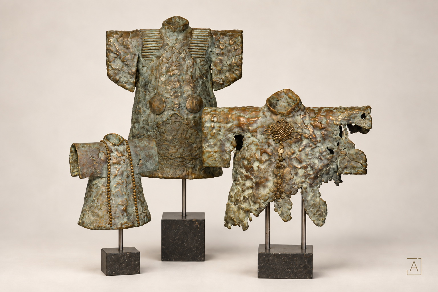 Three bronze kimono sculptures by Dinie Nomden on individual stands; edited presentation image